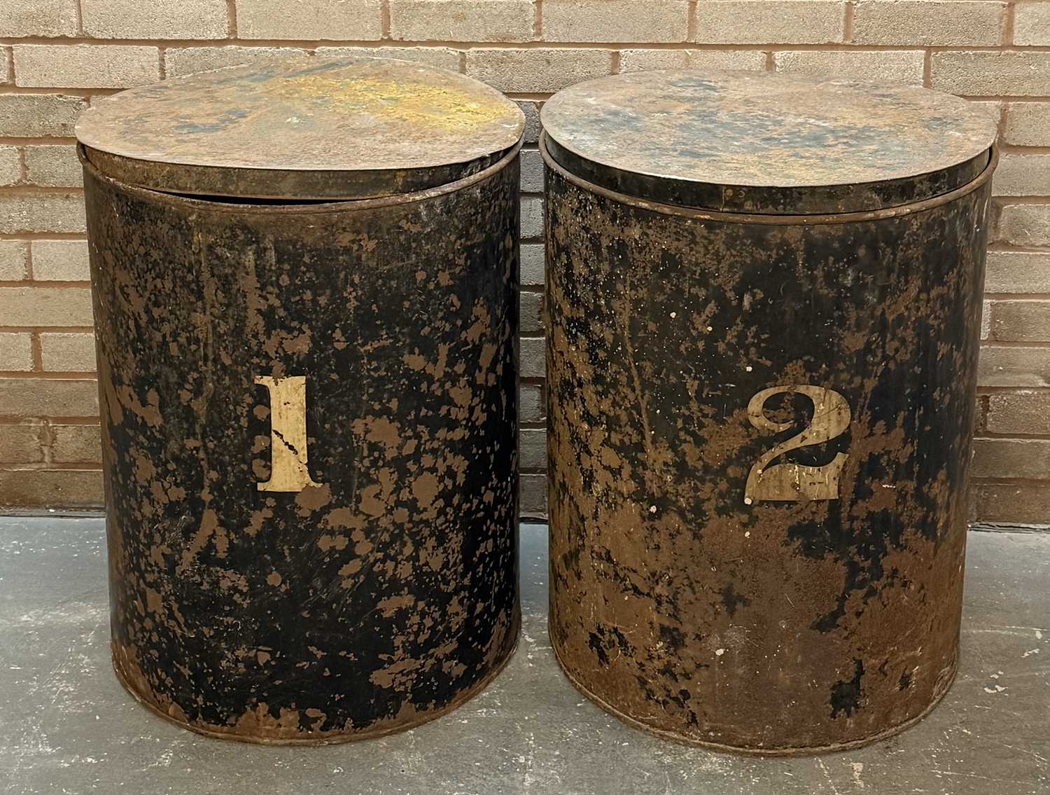 pair of vintage black japanned steel drums, numbered 1 and 2, with covers, 76 (h) x 59cms (d) pair of vintage black japanned steel drums, numbered 1 and 2, with covers, 76 (h) x 59cms (d)