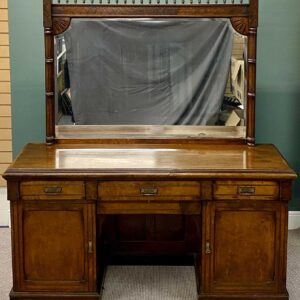 aesthetic movement walnut sideboard, late 19th century, the mirror back having spindle gallery top