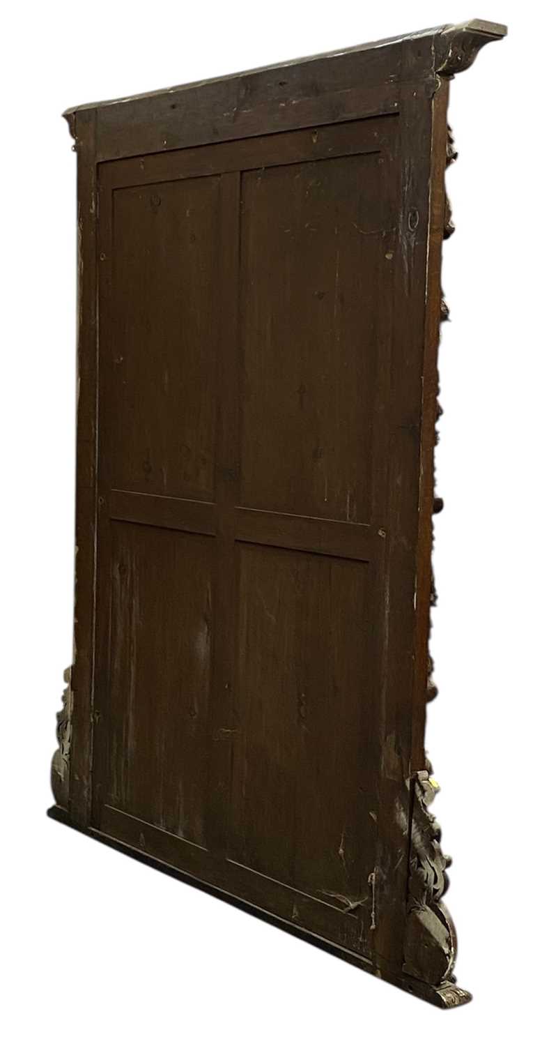 massive oak framed overmantel mirror, moulded cornice carved with leaves, surround deeply carved massive oak framed overmantel mirror, moulded cornice carved with leaves, surround deeply carved