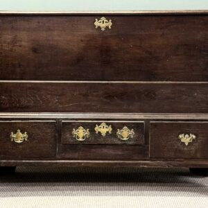 antique oak mule chest, rectangular hinged lid with moulded rim, over three drawers, brass drop