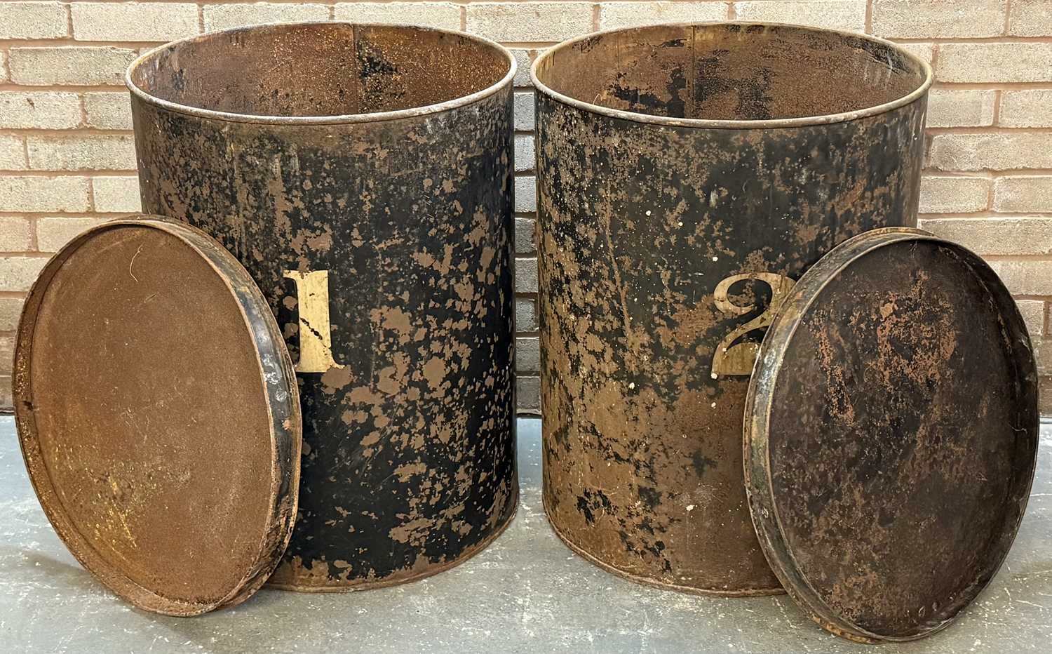 pair of vintage black japanned steel drums, numbered 1 and 2, with covers, 76 (h) x 59cms (d) pair of vintage black japanned steel drums, numbered 1 and 2, with covers, 76 (h) x 59cms (d)