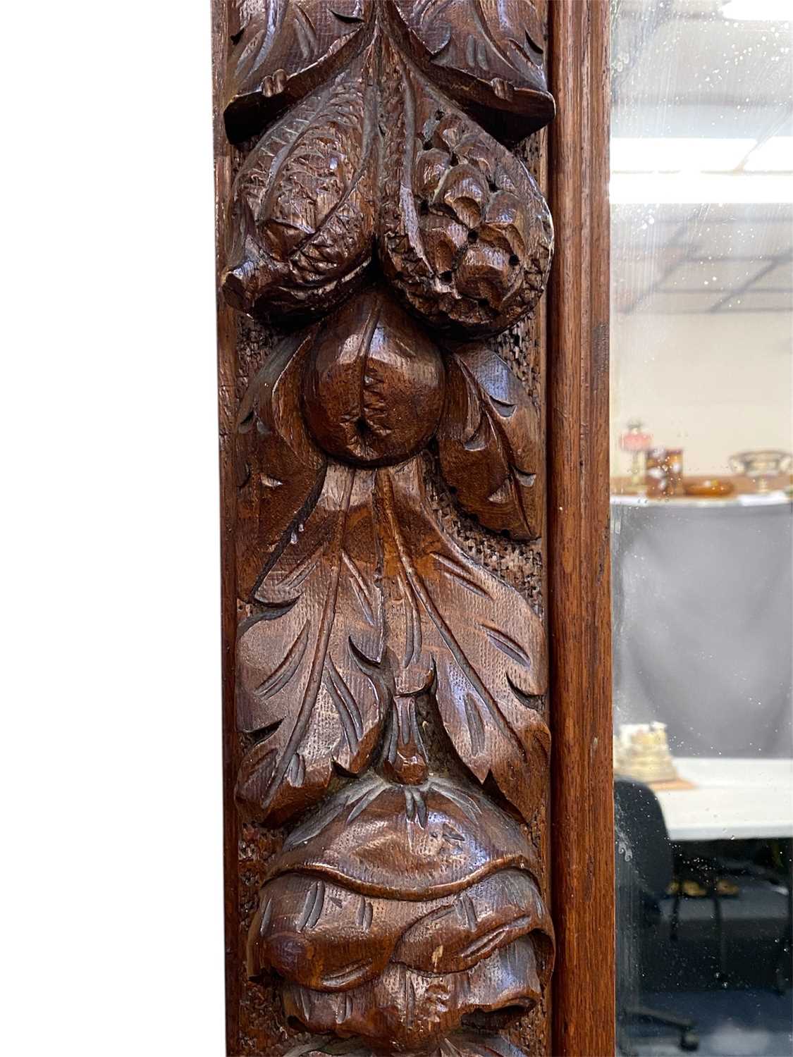 massive oak framed overmantel mirror, moulded cornice carved with leaves, surround deeply carved massive oak framed overmantel mirror, moulded cornice carved with leaves, surround deeply carved