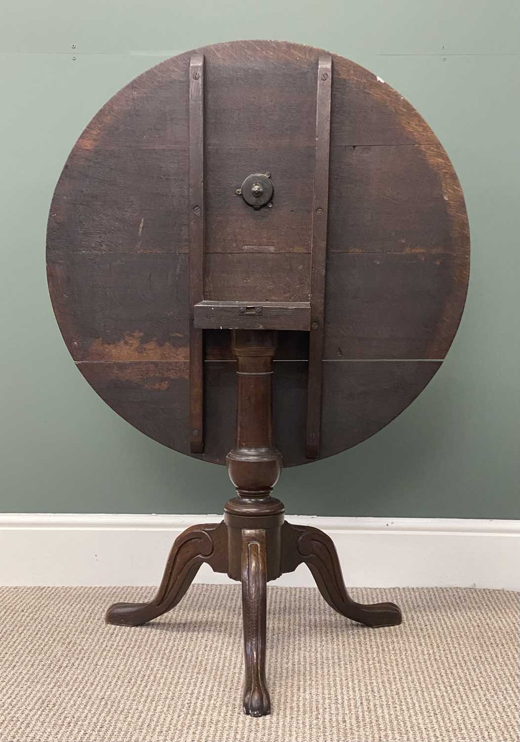 19th century oak tripod table, circular tilt top carved with a band of scrolls within a moulded 19th century oak tripod table, circular tilt top carved with a band of scrolls within a moulded