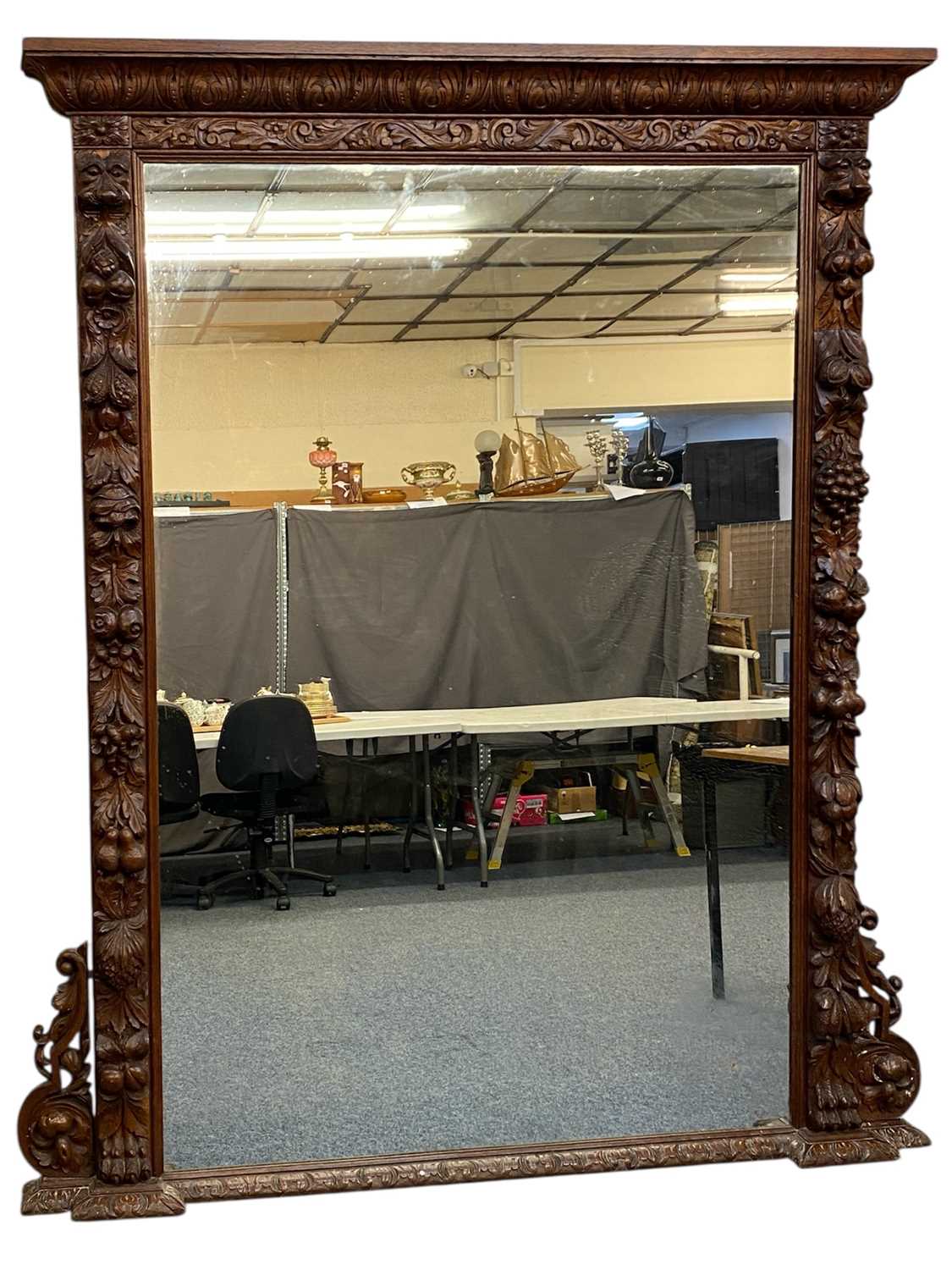 massive oak framed overmantel mirror, moulded cornice carved with leaves, surround deeply carved massive oak framed overmantel mirror, moulded cornice carved with leaves, surround deeply carved