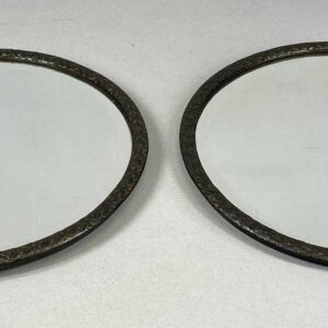 pair of vintage circular wall mirrors, with embossed copper frames and bevelled plates, 32.5cms