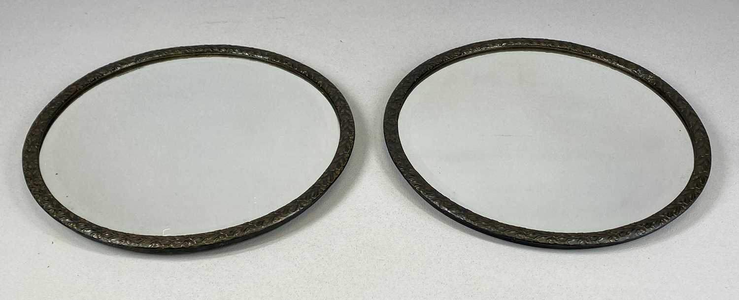 pair of vintage circular wall mirrors, with embossed copper frames and bevelled plates, 32.5cms pair of vintage circular wall mirrors, with embossed copper frames and bevelled plates, 32.5cms
